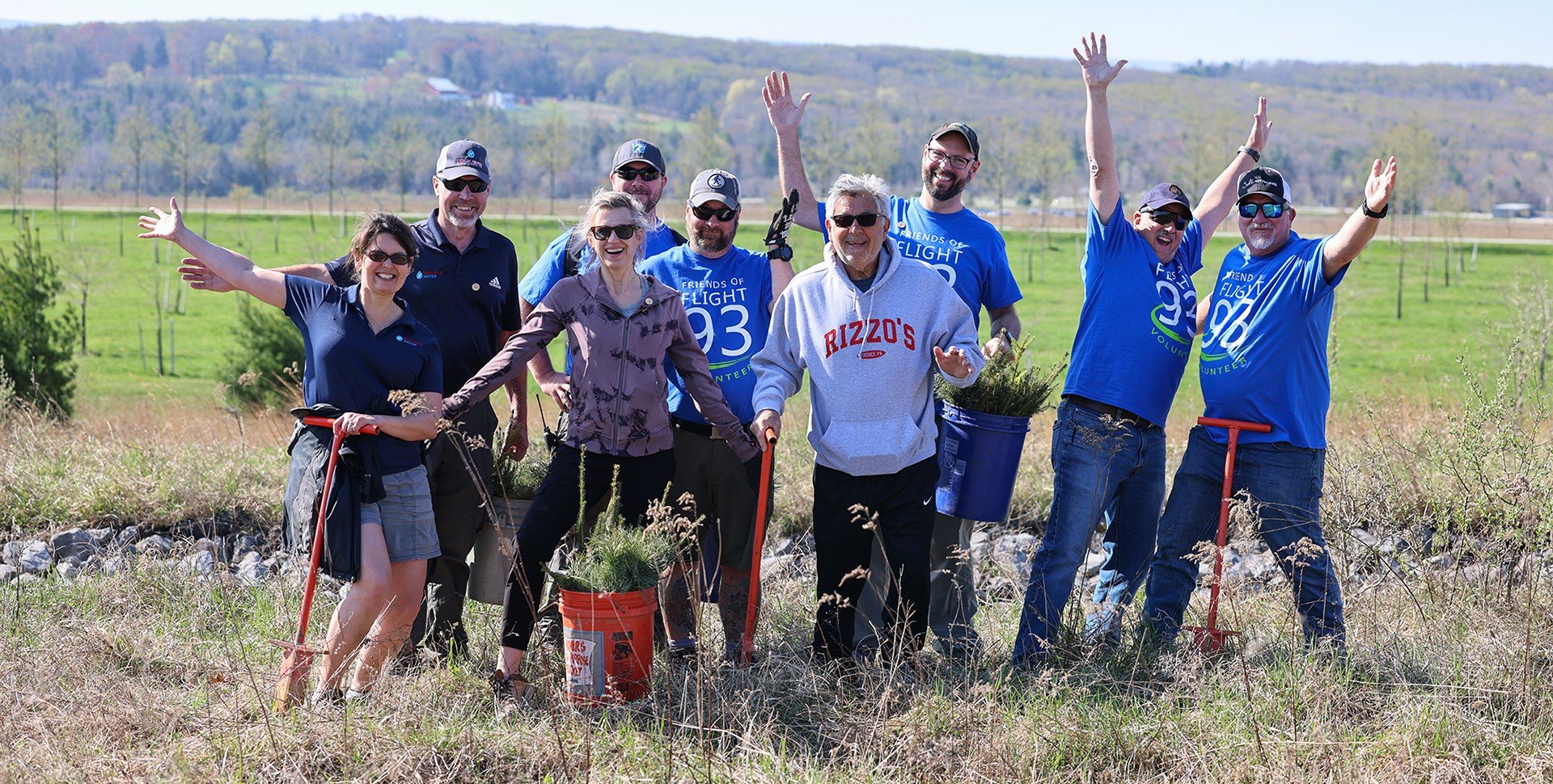 Volunteers posing for a picture outside.