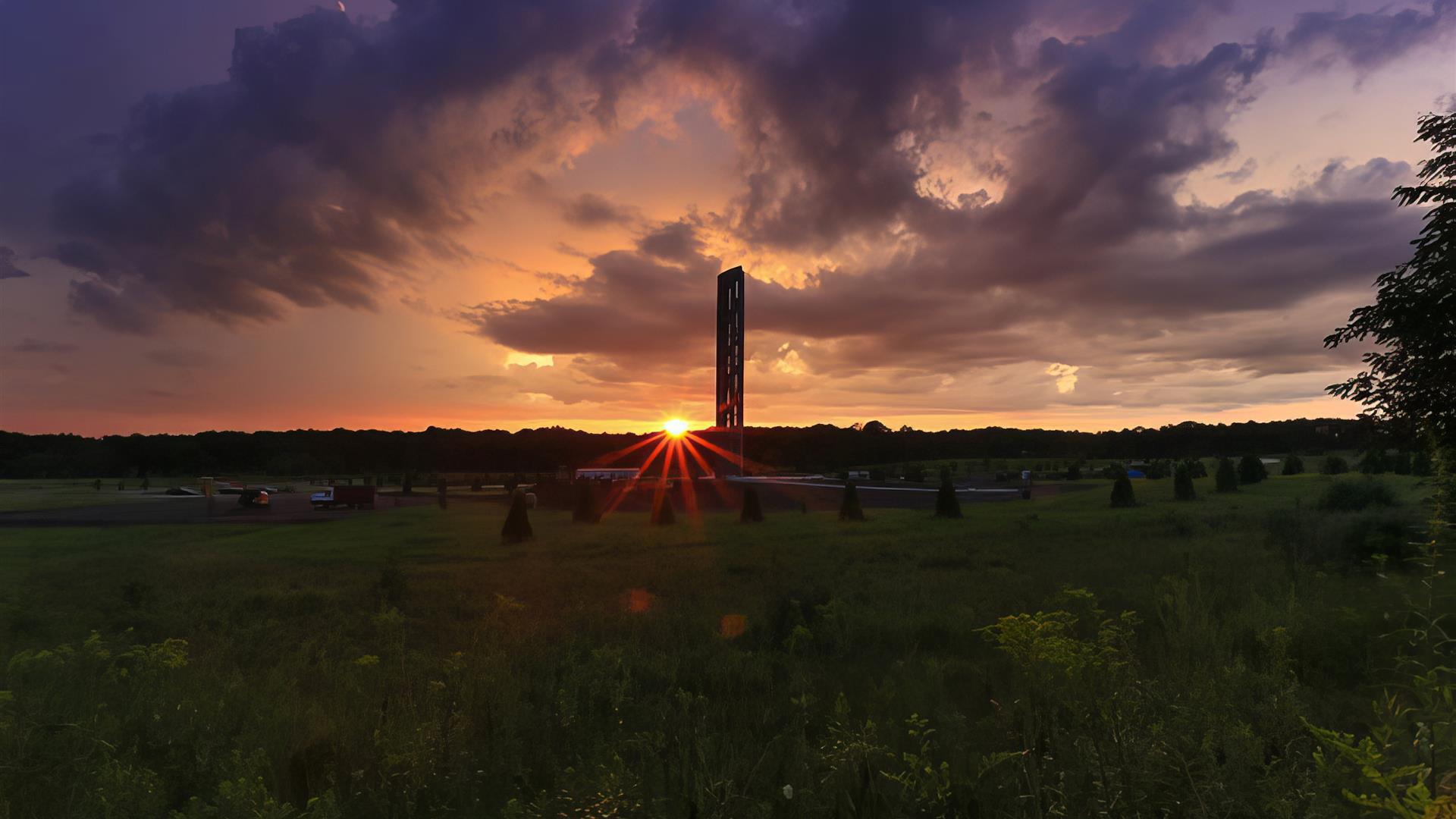 The memorial tower with the sun setting behind it