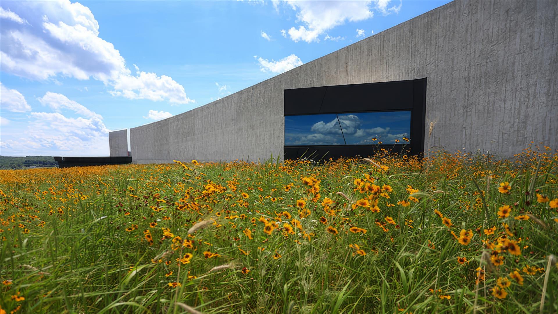 The memorial with yellow flowers in front of it