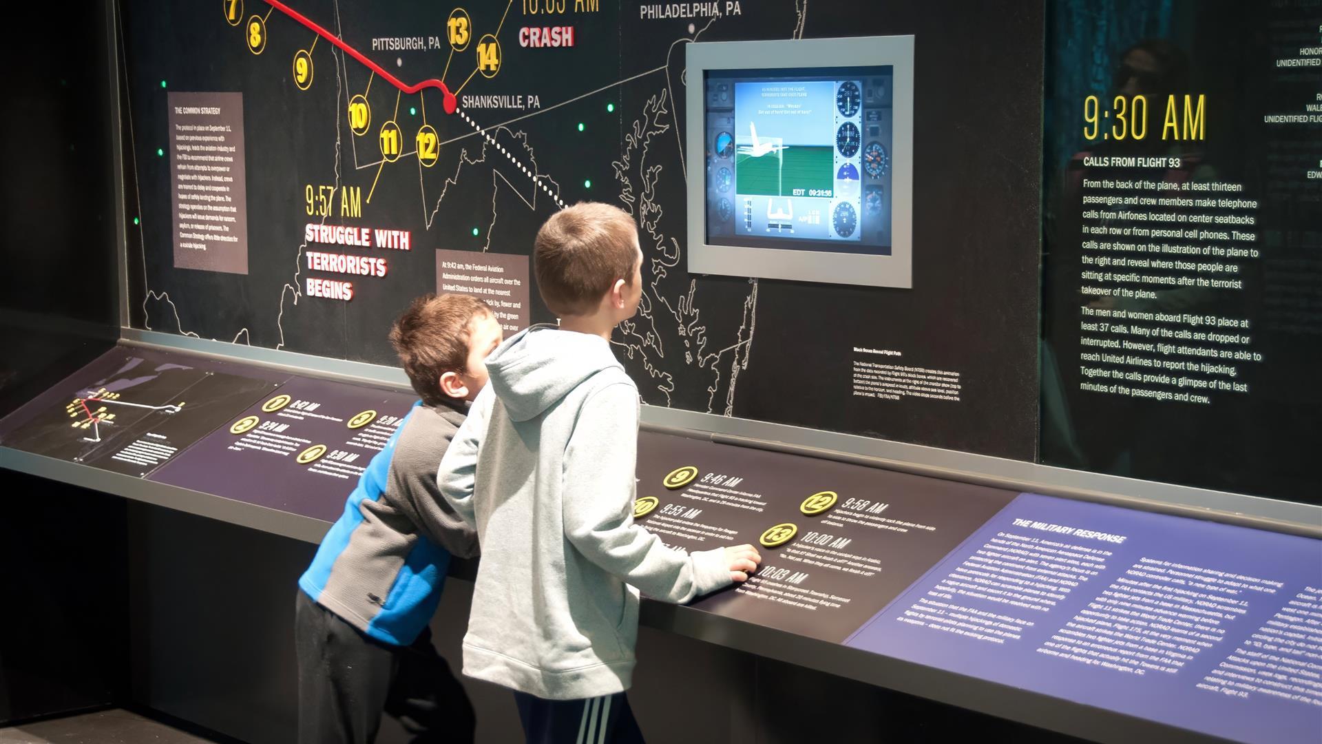 Kids learning on a monitor at an exhibit