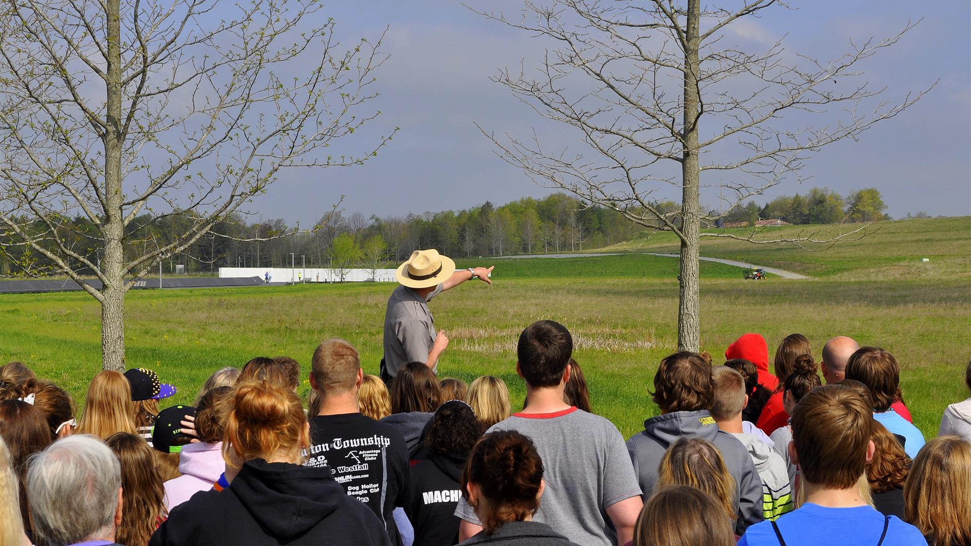 A National Park worker giving a tour to a crowd of people